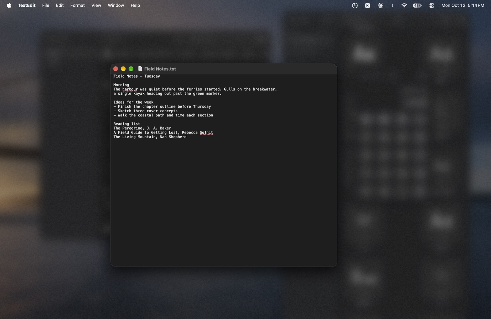 A text document in focus with the other windows and wallpaper blurred behind it